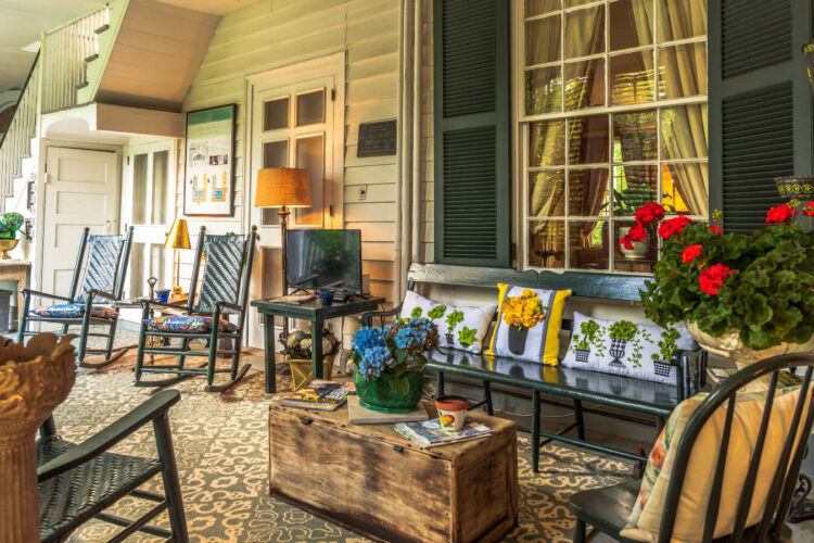 an outdoor porch with living room furniture with country furnishings